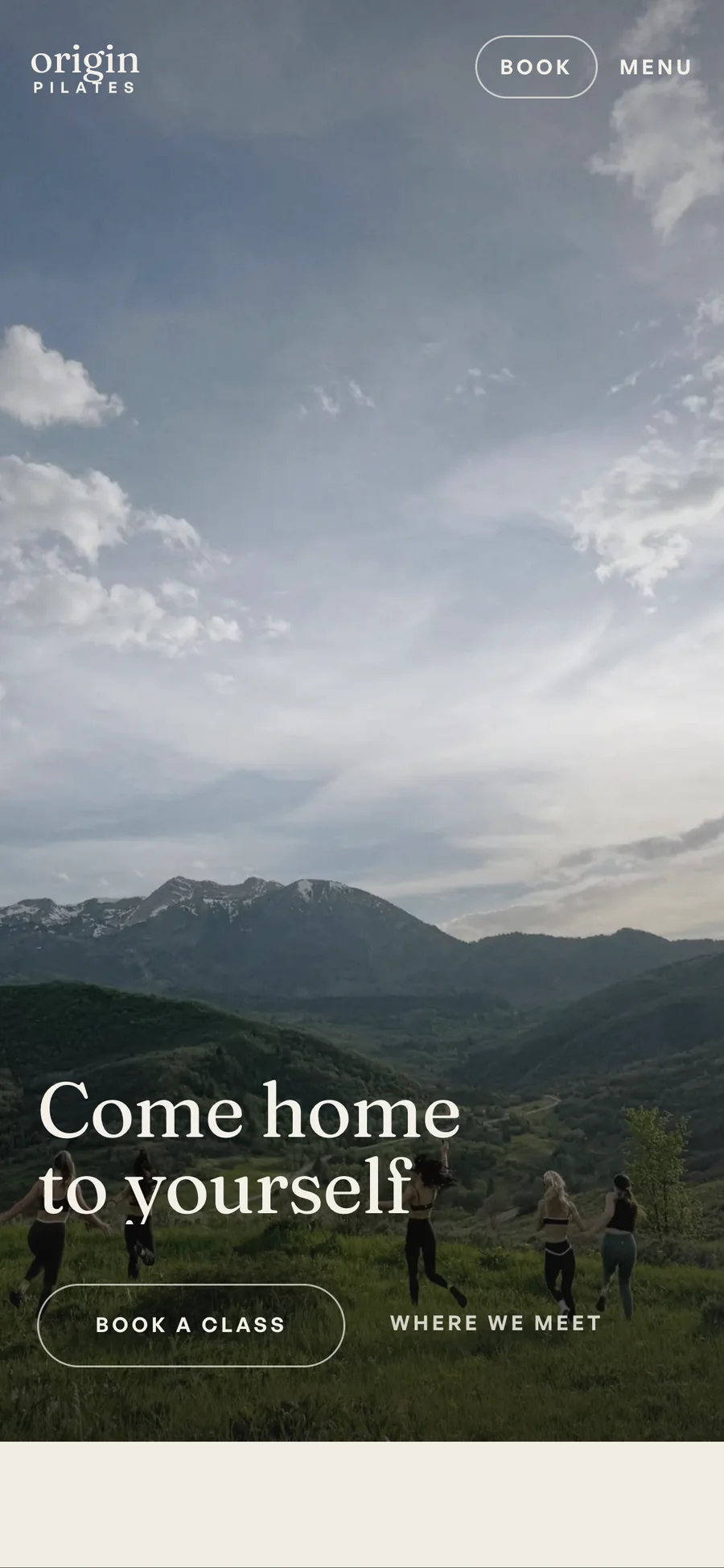 Origin Pilates on a phone: mountains under cloud, the line Come home to yourself, and a Book a class button.