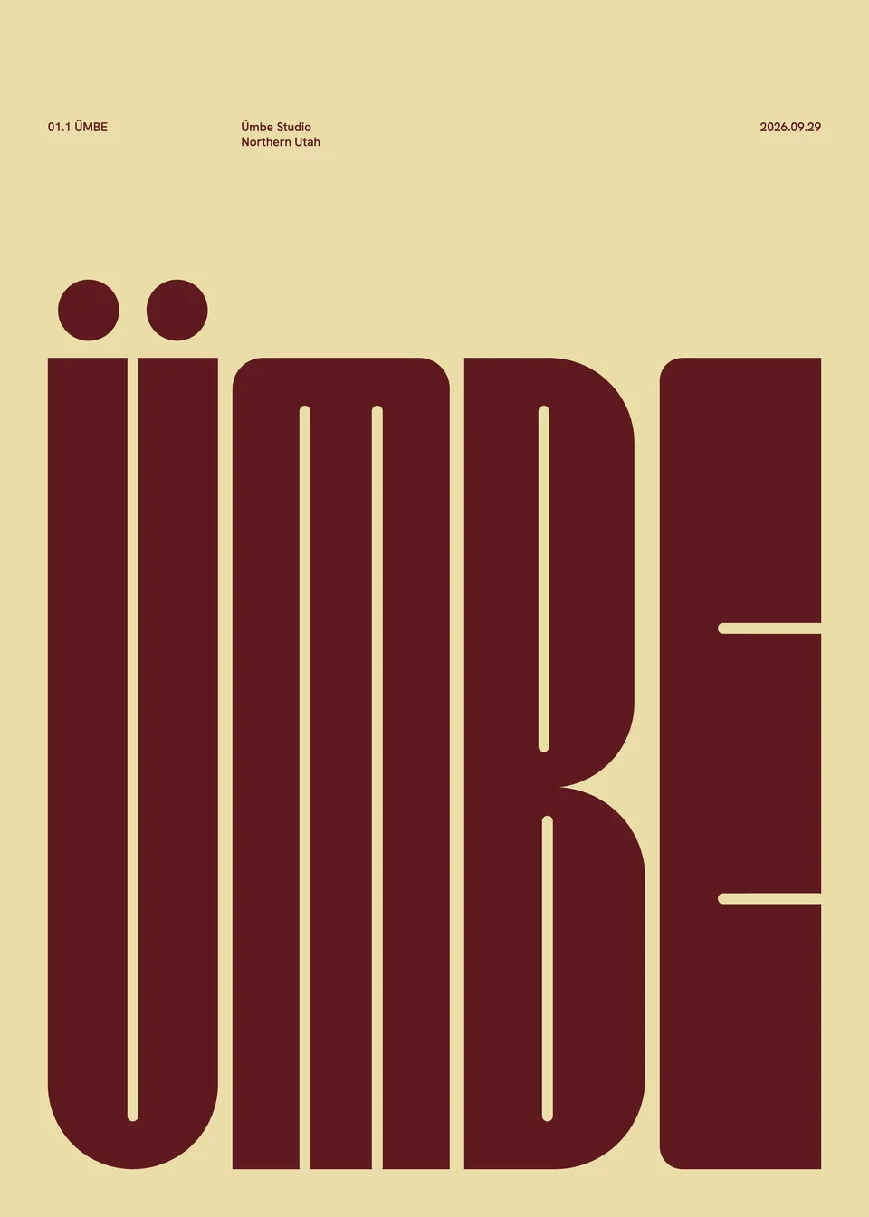 Print: ÜMBE in tall wine-coloured capitals filling a butter sheet, every counter a hairline slot, two round umlaut dots above the U.